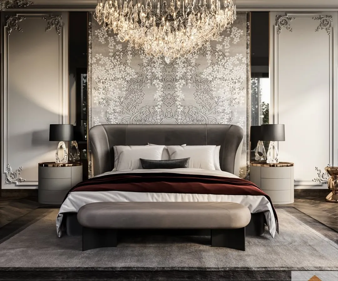 A master bedroom designed for pure luxury, with a stunning crystal chandelier, intricate wall mouldings, and a bespoke floral wallpaper that serves as a captivating centerpiece.