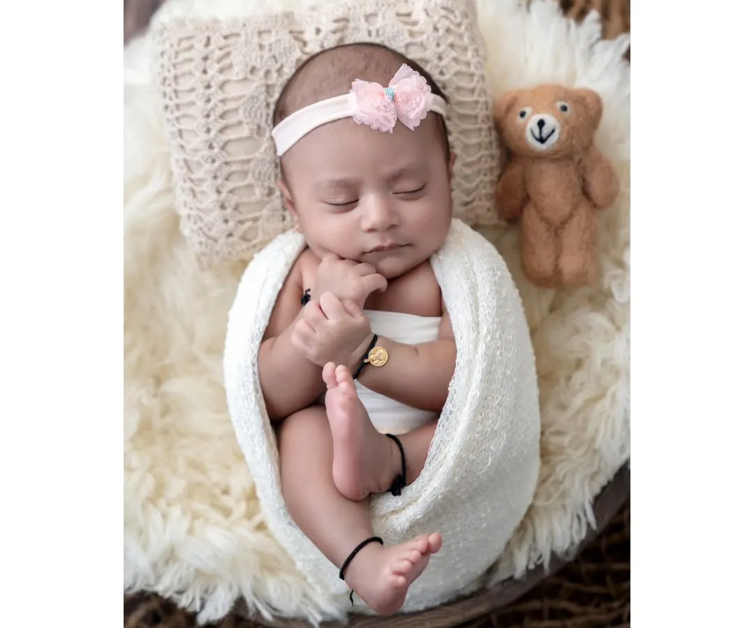 A perfect, peaceful portrait of a sleeping newborn. In my cozy Borivali studio, I create a safe and warm environment where your baby can rest comfortably, allowing me to capture these classic, angelic poses. This little one is swaddled and sleeping next to her tiny teddy bear companion.