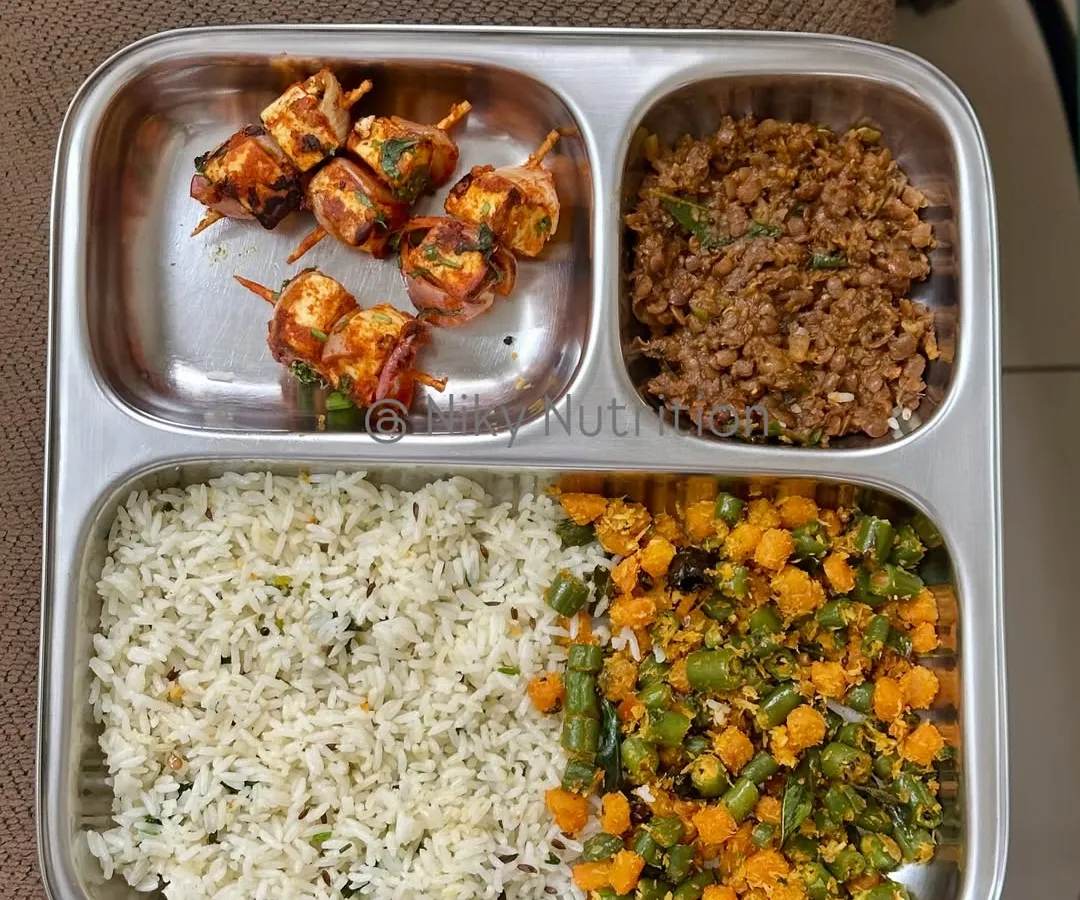 Who says healthy can't be exciting? This plate features delicious paneer skewers, offering a fantastic source of protein, alongside seasoned rice and a mix of vibrant, fiber-rich vegetables. It’s a perfect example of how I make nutritious food that you'll genuinely look forward to eating.
