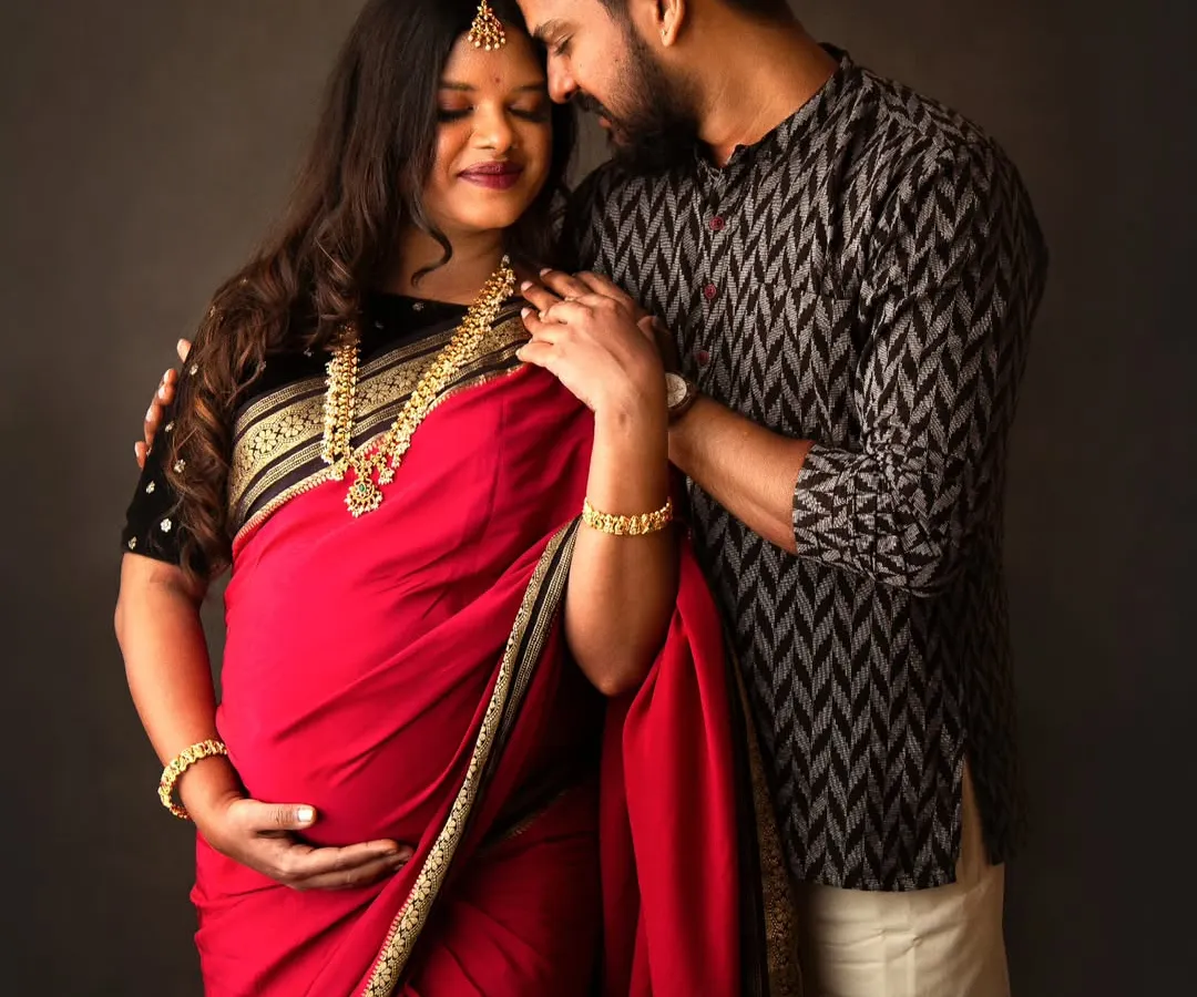 I had the absolute honor of capturing this tender moment between two renowned photographers. This traditional couple's maternity portrait, with them in a beautiful red saree and kurta, shows the deep connection and quiet joy of expecting parents.