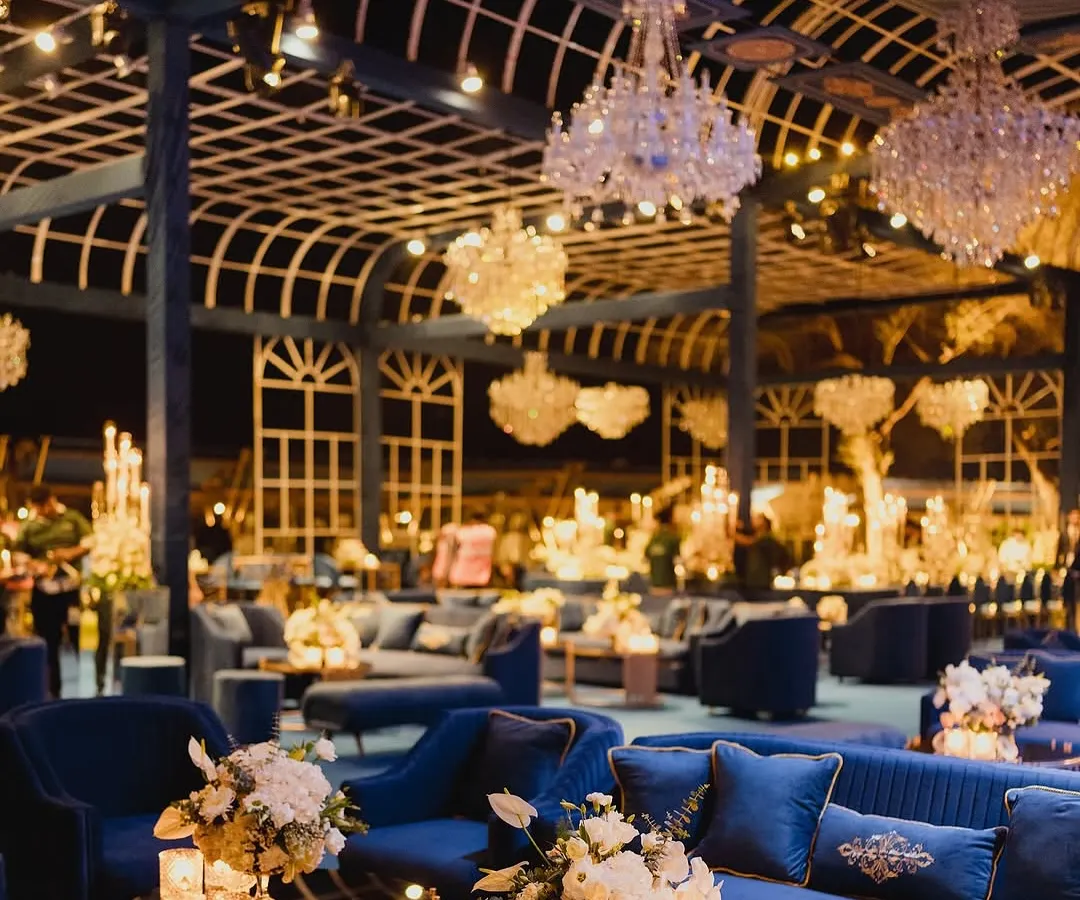 We transformed this venue into an opulent royal blue dreamscape for an evening celebration. The combination of plush velvet seating, countless crystal chandeliers, and dramatic white floral arrangements created an atmosphere of pure, sophisticated luxury.