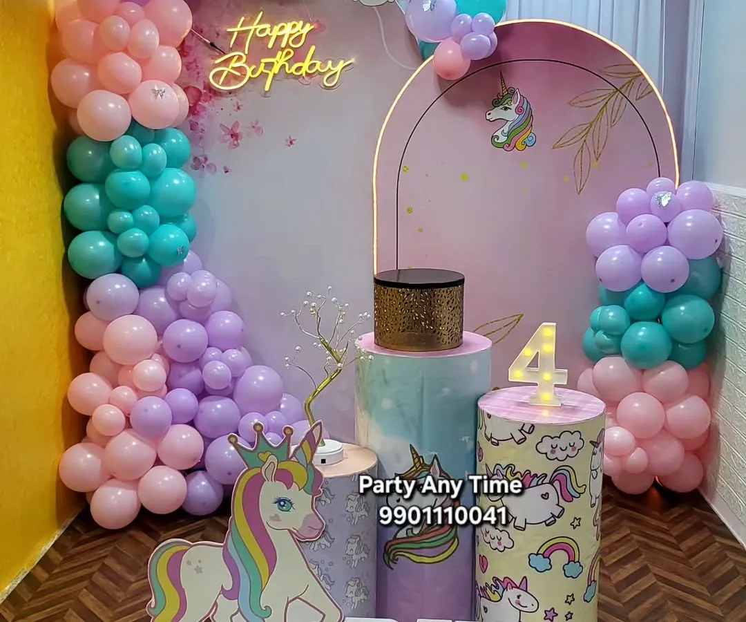 I create magical unicorn-themed parties for kids. This setup for Riya's 4th birthday features a pastel balloon garland, a custom unicorn backdrop, character cutouts, and themed plinths for the cake.