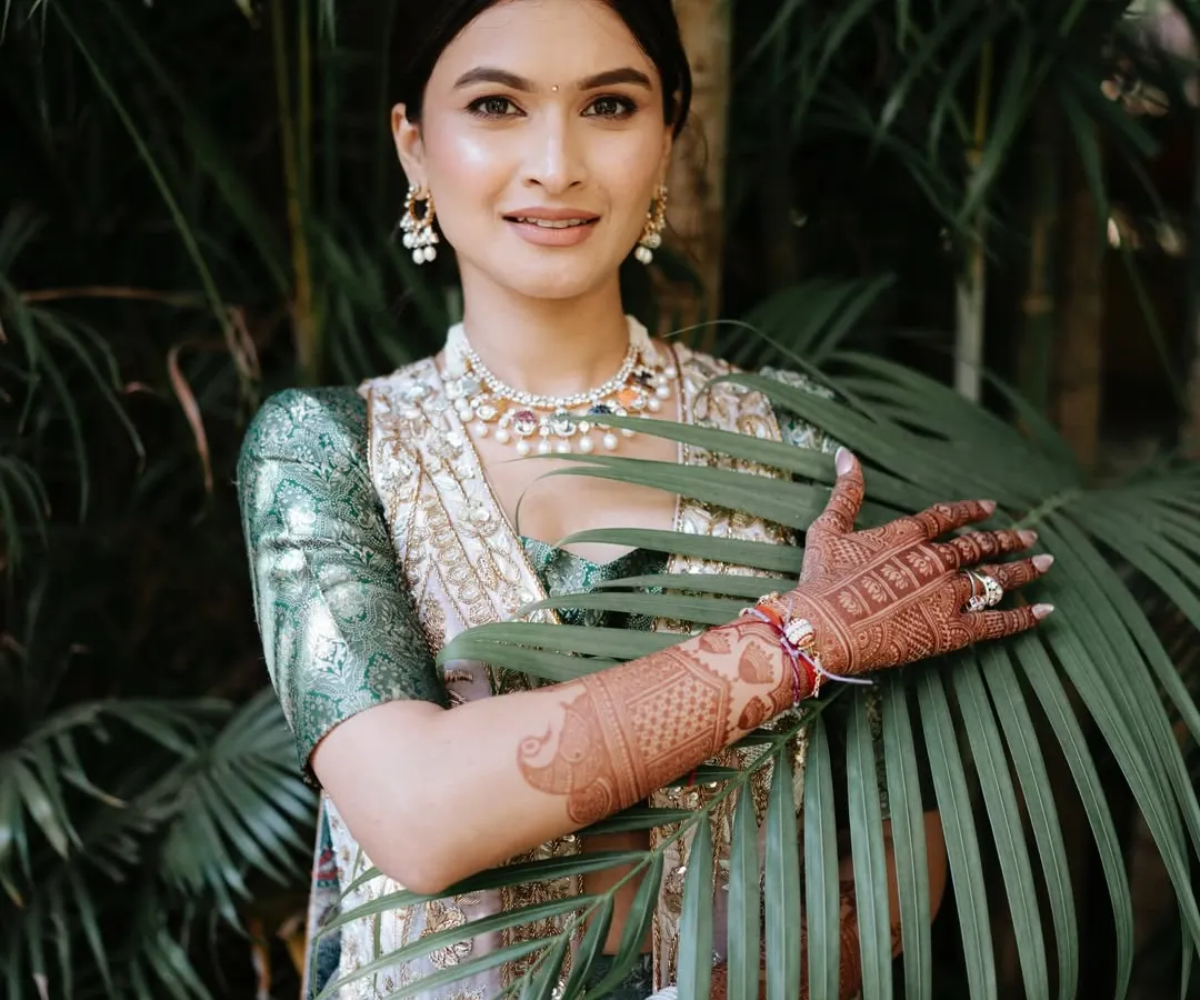 For daytime events like a Mehendi, I love creating a fresh and minimal look. Here, I focused on achieving my signature dewy skin, complemented by a simple hairstyle and subtle makeup that feels light and comfortable in any destination's climate.