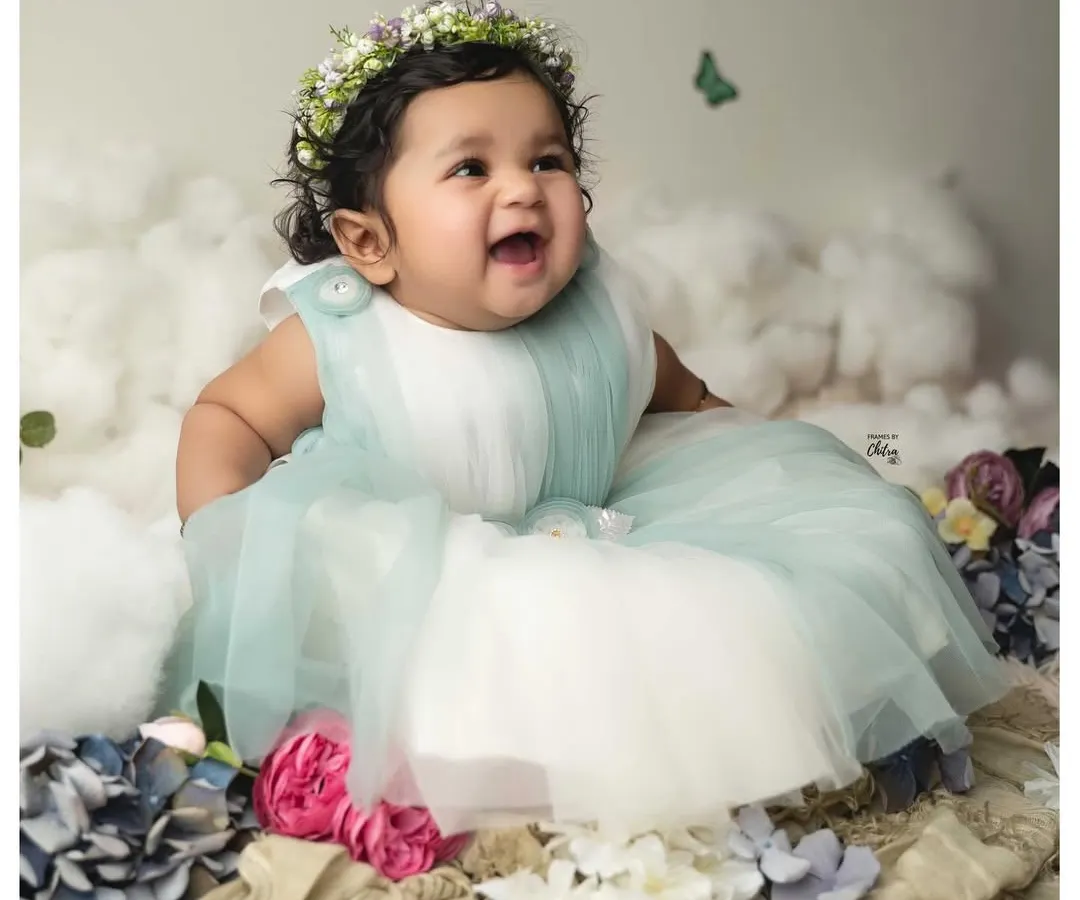 Celebrating six months of pure magic. This little one's happy expression is captured in a dreamy setup with soft clouds and a floral crown. My six-month milestone sessions are designed to showcase your baby's budding personality and those adorable gummy grins.