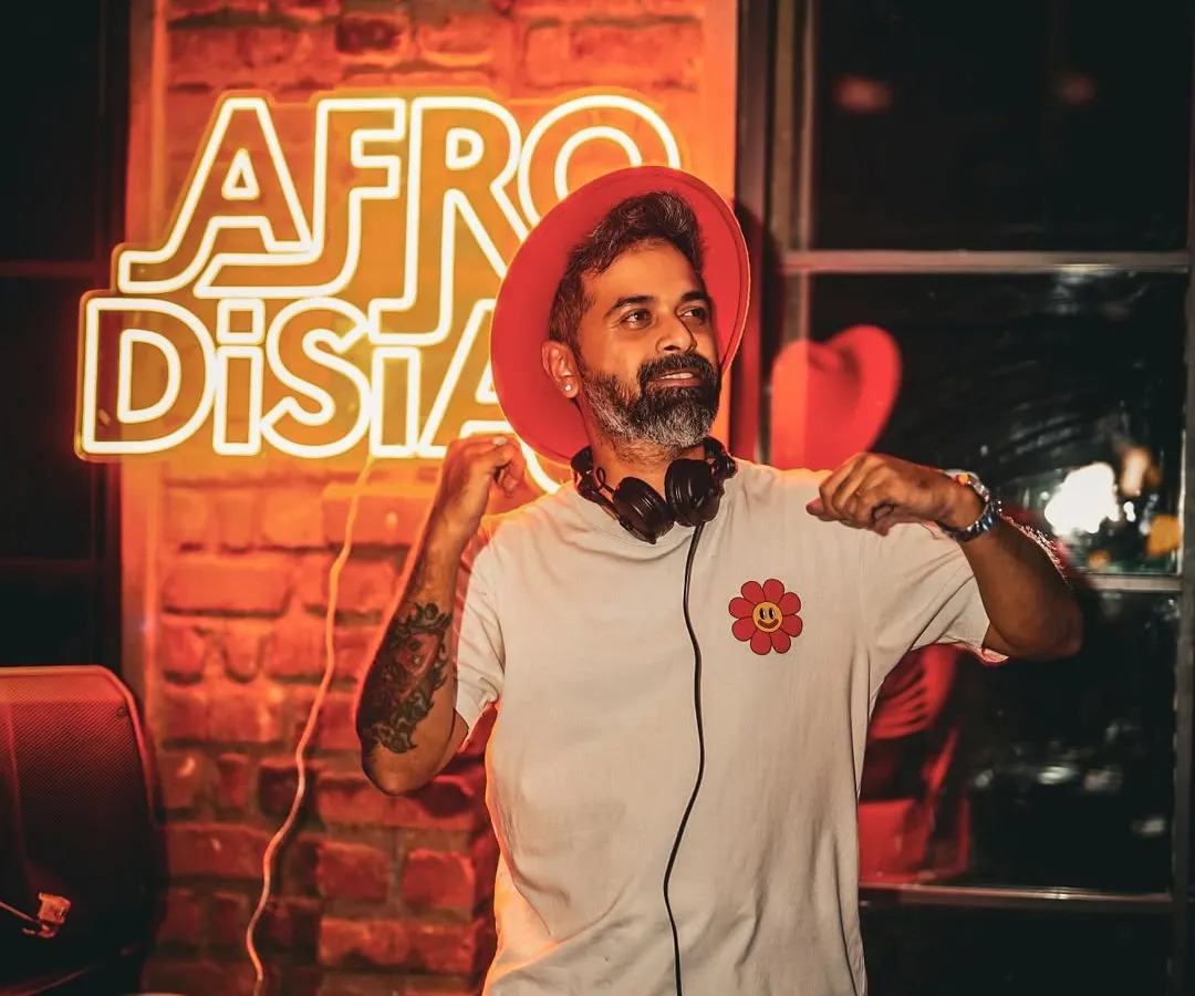 In my element at an Afrodisiac night, my signature event series dedicated to the best Afro house and Latin beats. The neon sign says it all. This is where I get to share the music I'm most passionate about, creating a unique, rhythm-filled atmosphere.