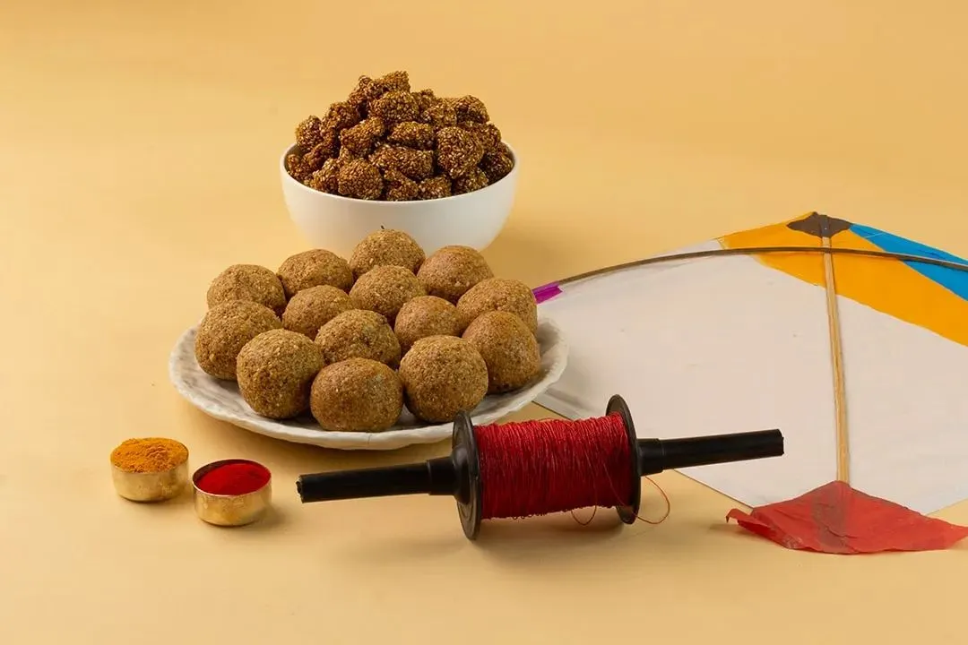 A clean and festive shot styled for Makar Sankranti. I arranged traditional sweets like til ladoo and gajak with props like a kite and thread spool to create a culturally relevant and appealing image for seasonal marketing.