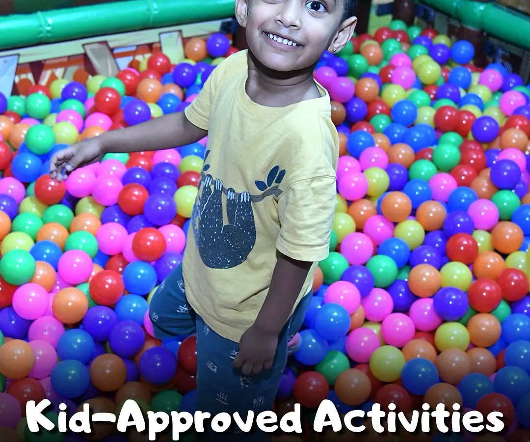 Look at that smile! My indoor play area is packed with kid-approved activities, including this giant, colorful ball pit that guarantees hours of fun. It's a safe and exciting space where kids can just be kids.