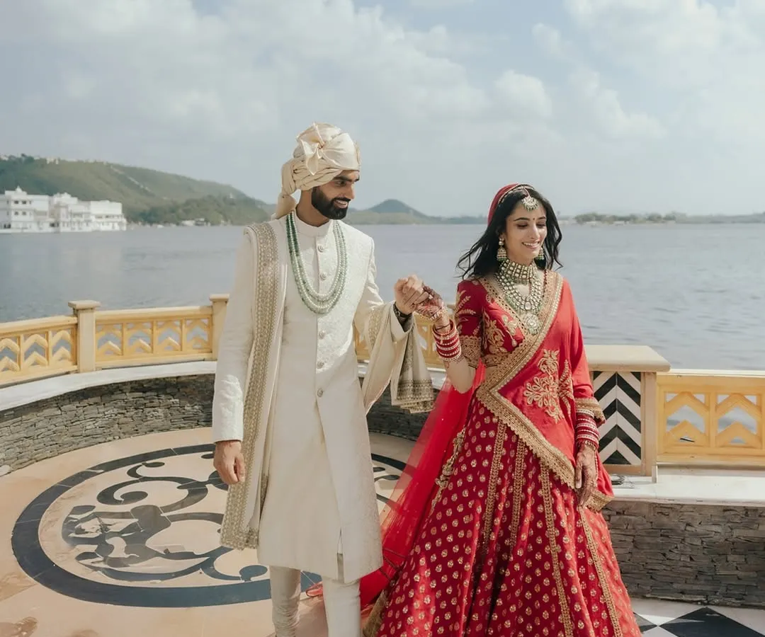 Capturing the grandeur of a royal destination wedding in Udaipur. The majestic backdrop of the lake palace adds a layer of history and romance to this couple's walk into their future.