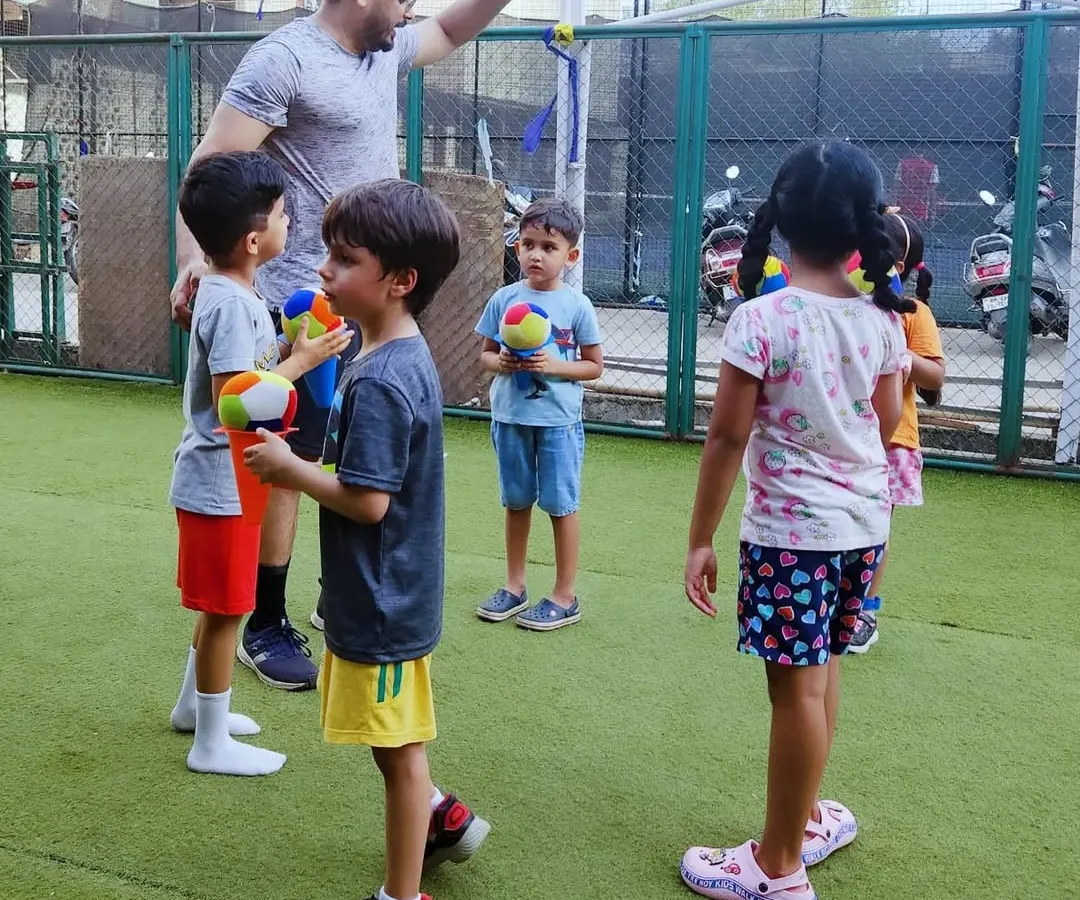 Here I am with one of my groups, getting ready for a ball game. I make sure every session has a low coach-to-child ratio, so I can give each child the attention they need to learn, play, and feel included in the fun.