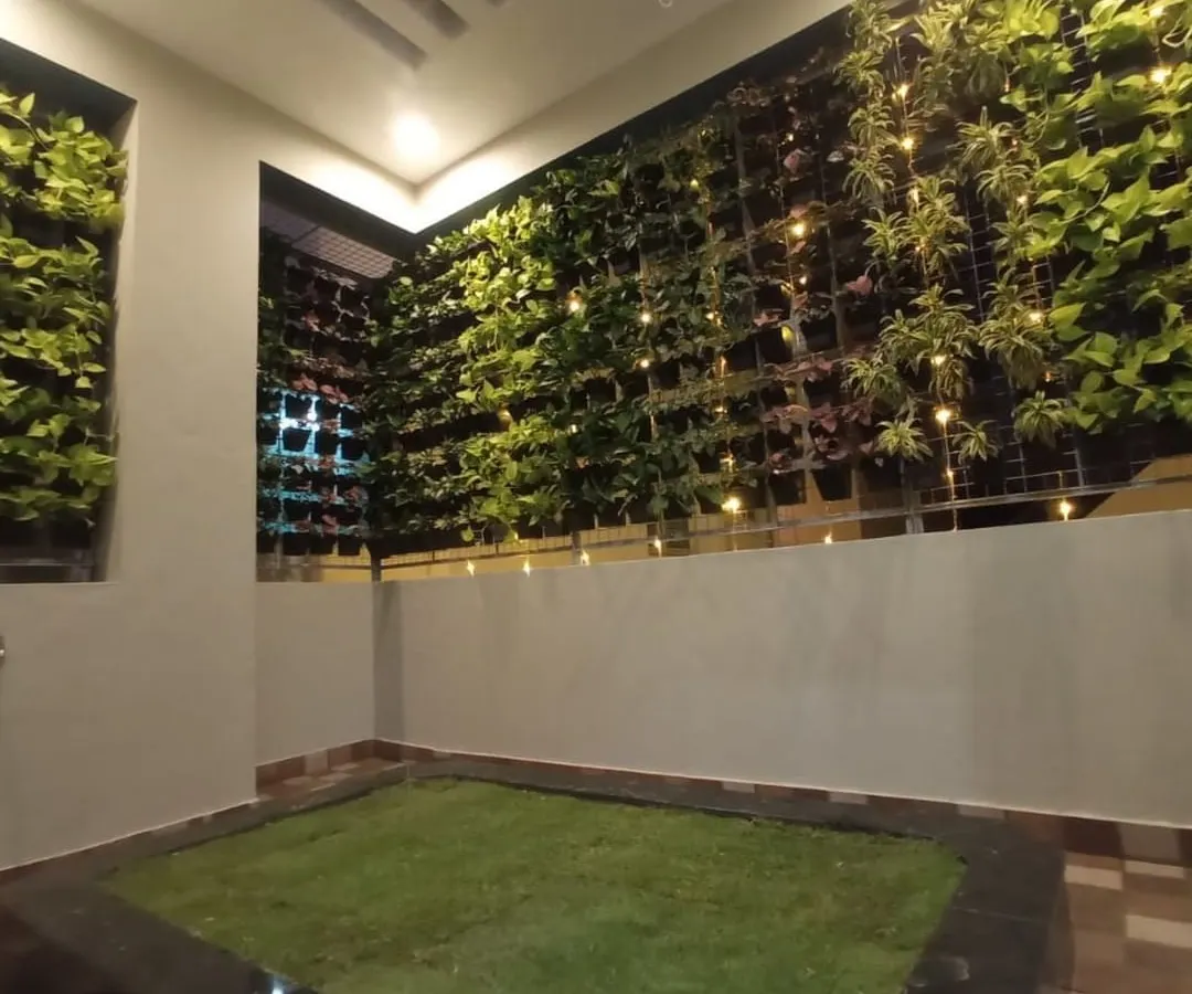 Even compact spaces can become a green sanctuary. We designed and installed this extensive vertical garden, or living wall, complemented by a patch of soft lawn and ambient lighting for a stunning evening view.