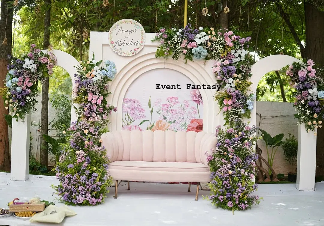 For a modern and romantic engagement, I designed this beautiful pastel floral backdrop. The soft pink couch, surrounded by lush arrangements of roses and hydrangeas against custom arches, created the perfect dreamy atmosphere for Anupa and Abhishek.