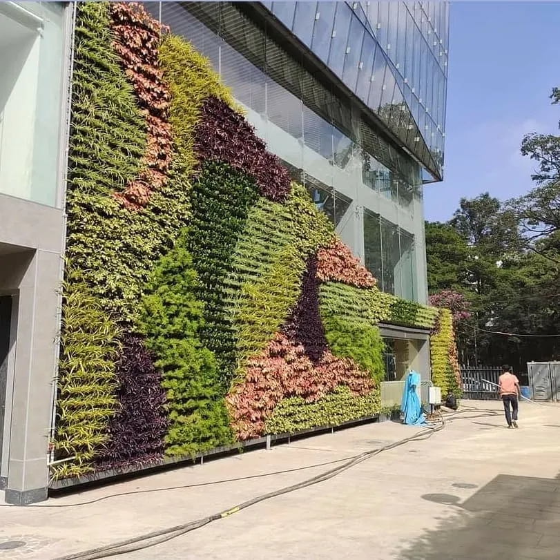 This is an example of a large-scale commercial project, where I installed a multi-story vertical garden on a modern glass building facade, creating a massive visual impact.