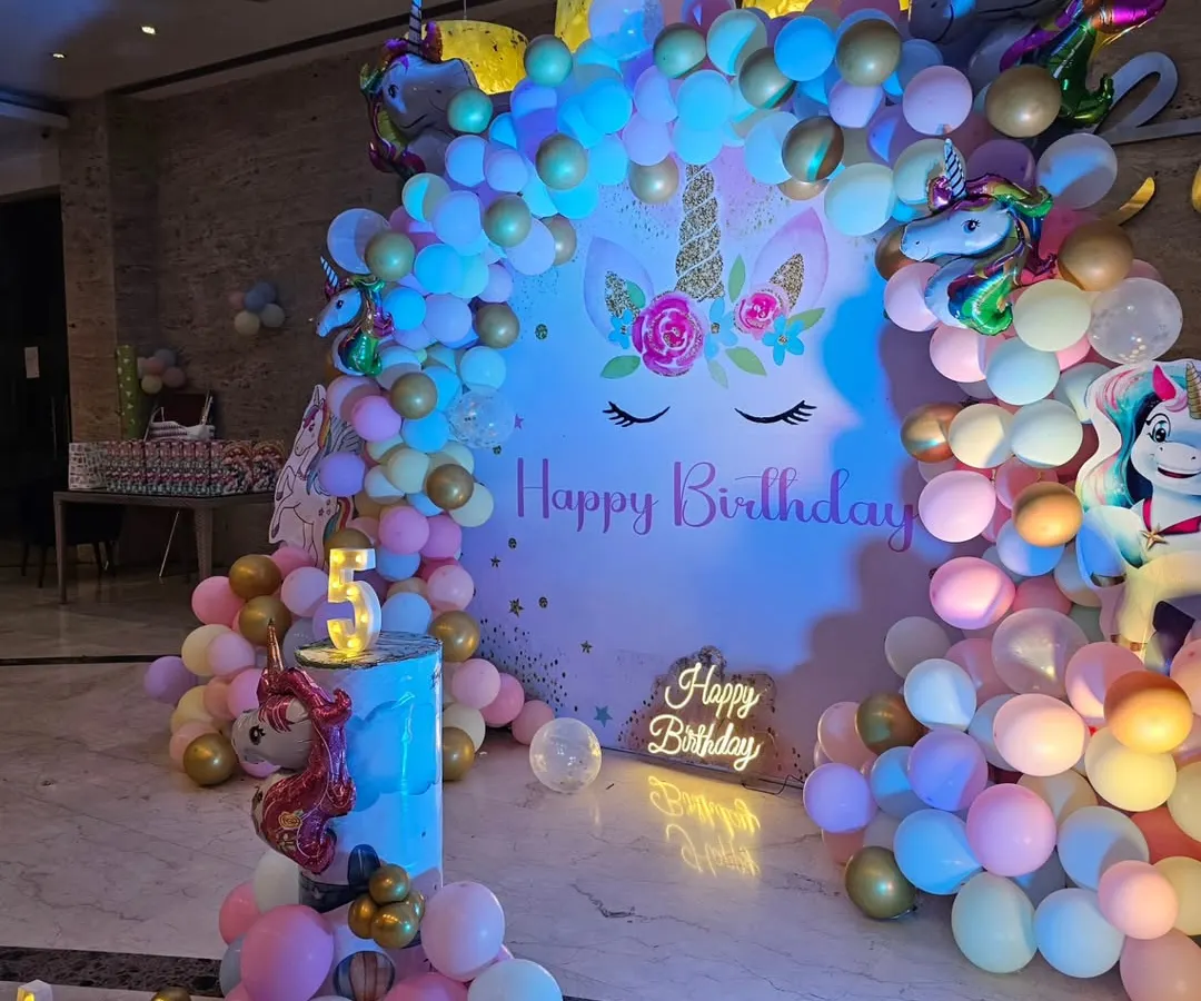 I specialize in creating magical themed birthday parties for kids. This unicorn-themed setup includes a custom backdrop, a multi-colored balloon arch, character cutouts, and marquee lights to spell out the birthday girl's name.