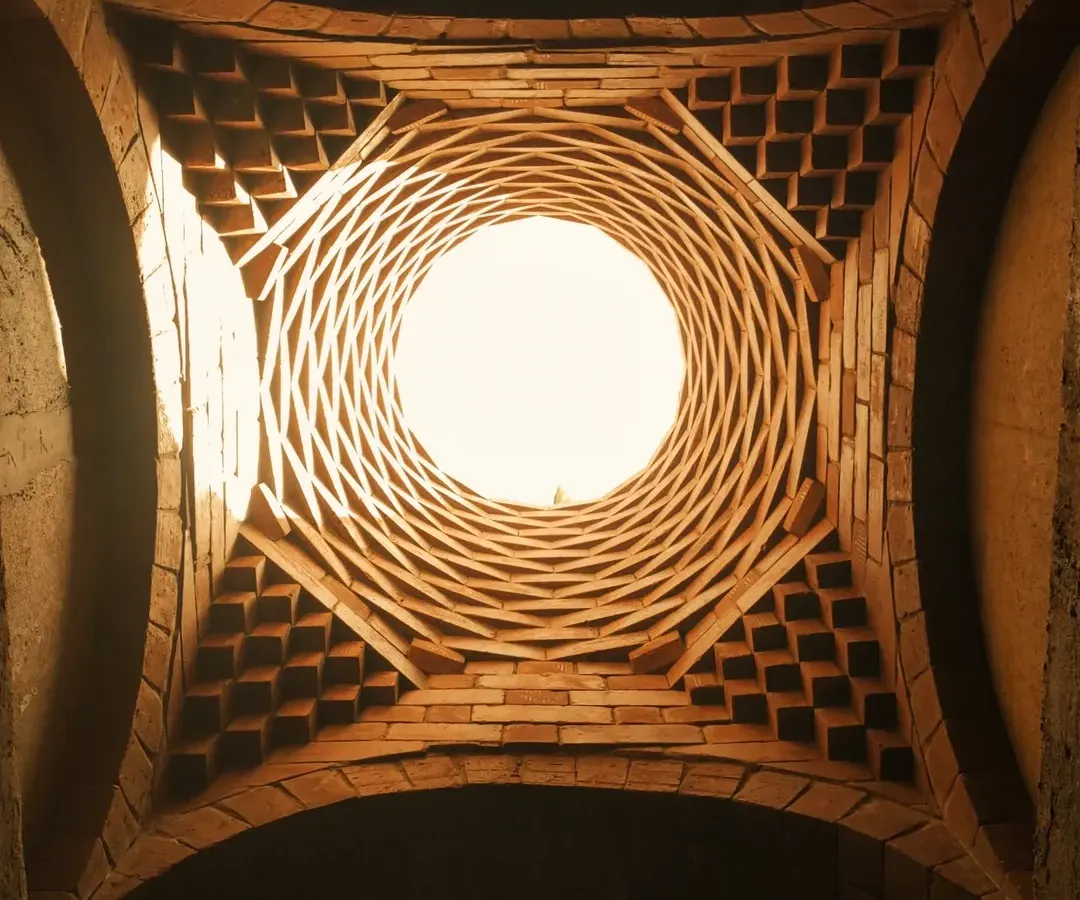 This is the oculus of an ornamental brick dome we created for a meditation space. The intricate corbelled brickwork is not just structural but also sculptural, playing with light and shadow to create a serene, inspiring atmosphere.