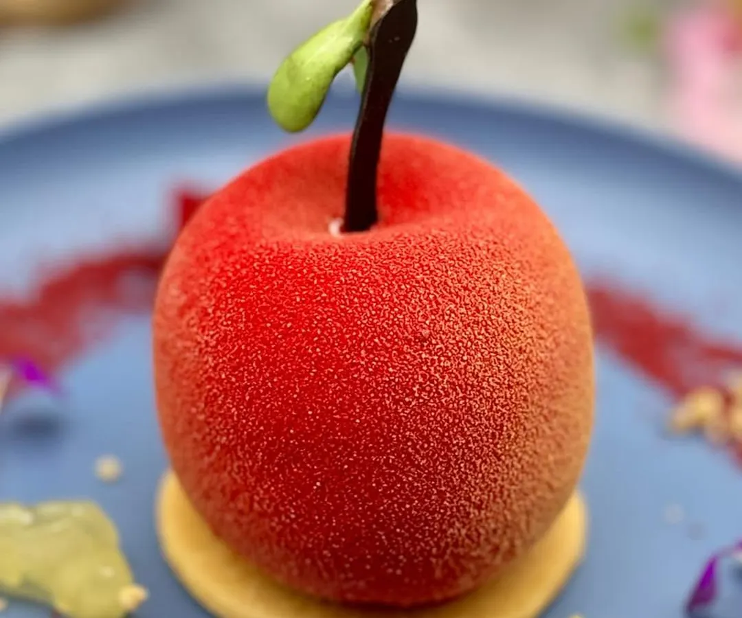 We believe in turning food into edible art. This dessert, crafted to look exactly like a real apple, is a testament to our team's creativity and skill, offering a delightful surprise with its hidden layers of flavour.