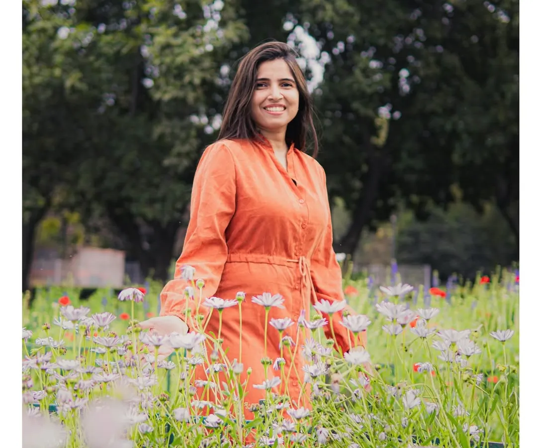 A simple, joyful portrait session in one of Delhi's beautiful gardens. My focus here was on using the natural light and vibrant colors of the flowers to complement her bright personality, creating a relaxed and authentic lifestyle photo.