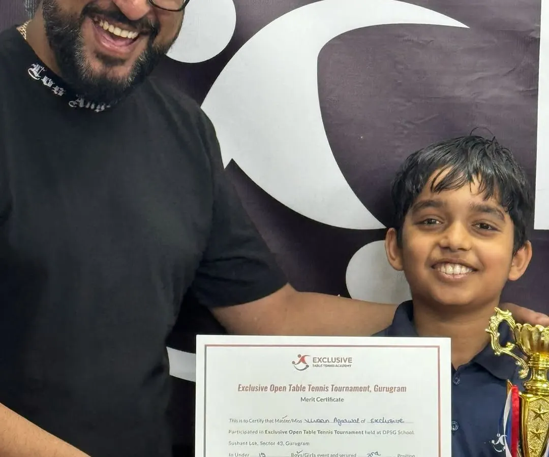 This is the moment it's all for. A huge smile from one of our young champions holding his well-earned trophy and certificate from our Exclusive Open Table Tennis Tournament. Seeing this joy is what drives me.
