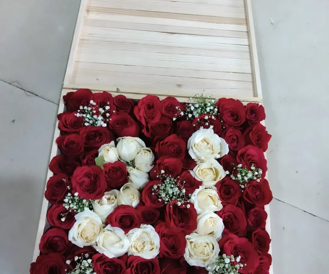 This is our most popular creation and a perfect example of what we do best: affordable elegance. We design these custom wooden gift boxes with the initial of your loved one, crafted from beautiful red and white roses. It's a personal, high-impact surprise that looks luxurious without the high price tag. Let us know the initial you need, and we'll create a memorable gift for any birthday, anniversary, or special occasion.