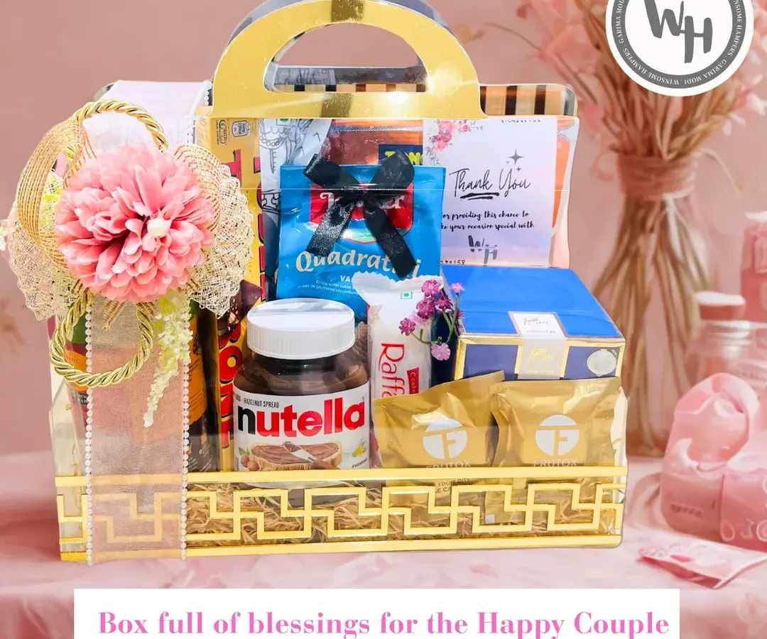 For the happy couple, I craft wedding hampers filled with blessings and indulgence. This beautiful hamper in a golden acrylic basket includes everything from Nutella and Raffaello to other premium treats, all elegantly packed.