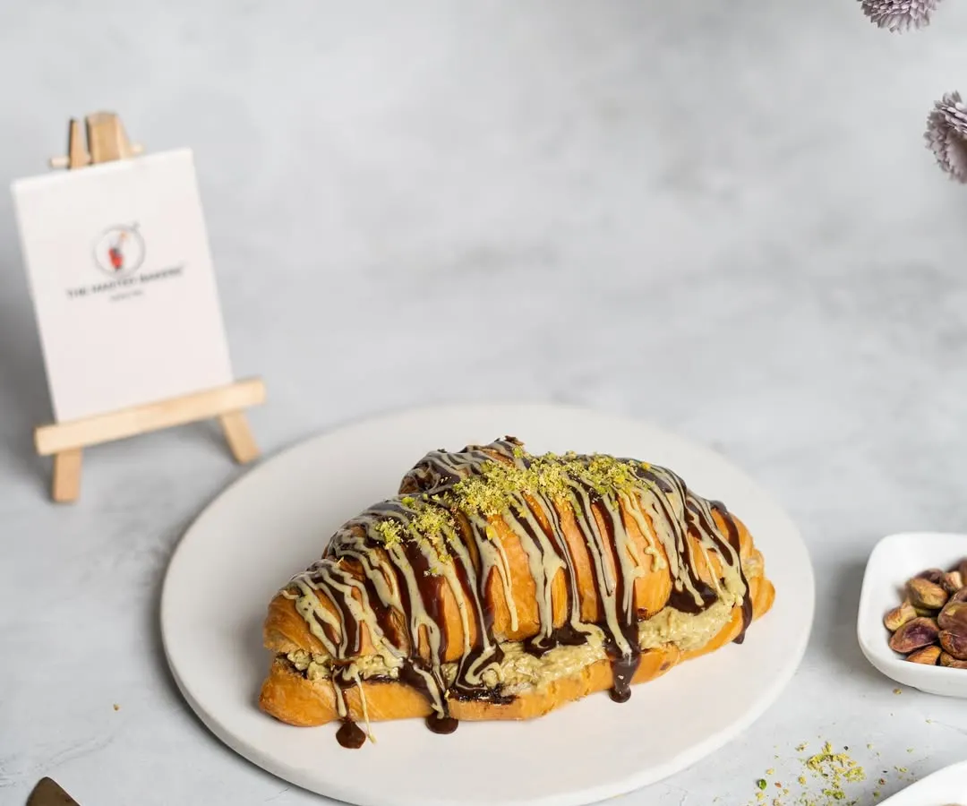 Meet our famous Croissant Prashant. We took a flaky, buttery croissant, stuffed it with sweet and crispy kunafa, and drizzled it with chocolate. It's the unique flavor and texture combination that started a craze.
