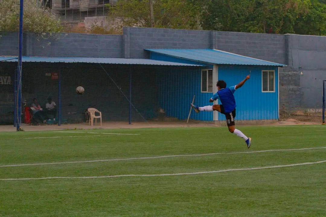 A player captured in a moment of pure power, executing a full-extension kick during a competitive match on our turf. This is the level of action our facility inspires.
