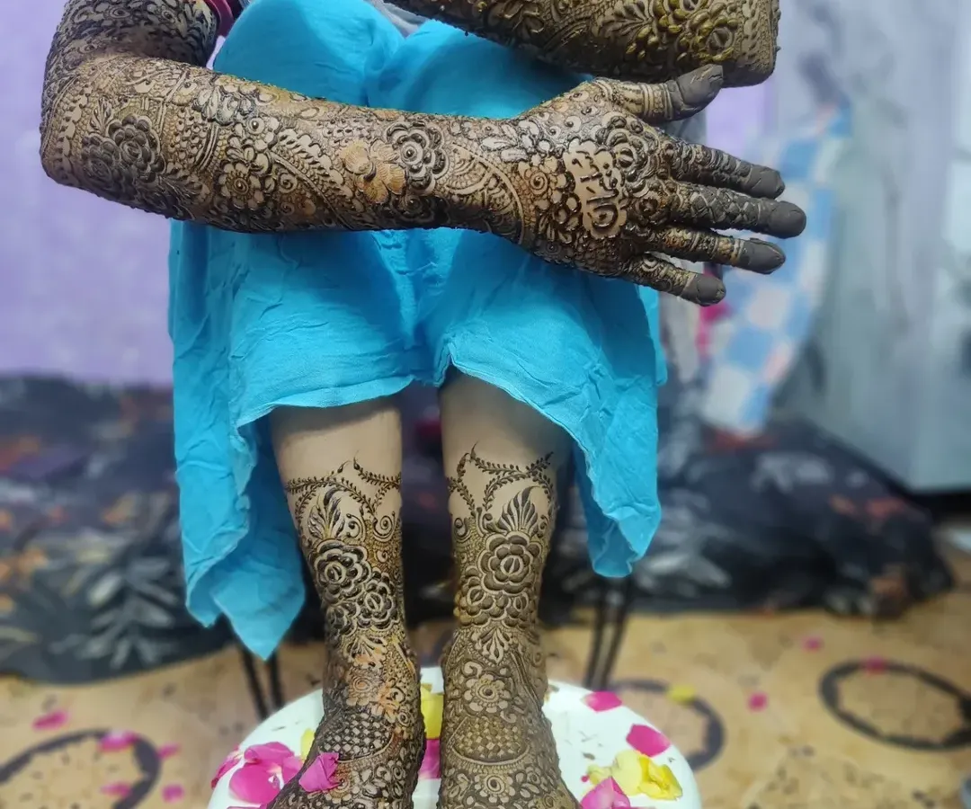 The complete bridal look, with detailed mehndi from fingertips to elbows and covering the feet. I love creating a design that flows beautifully for the entire wedding ceremony.