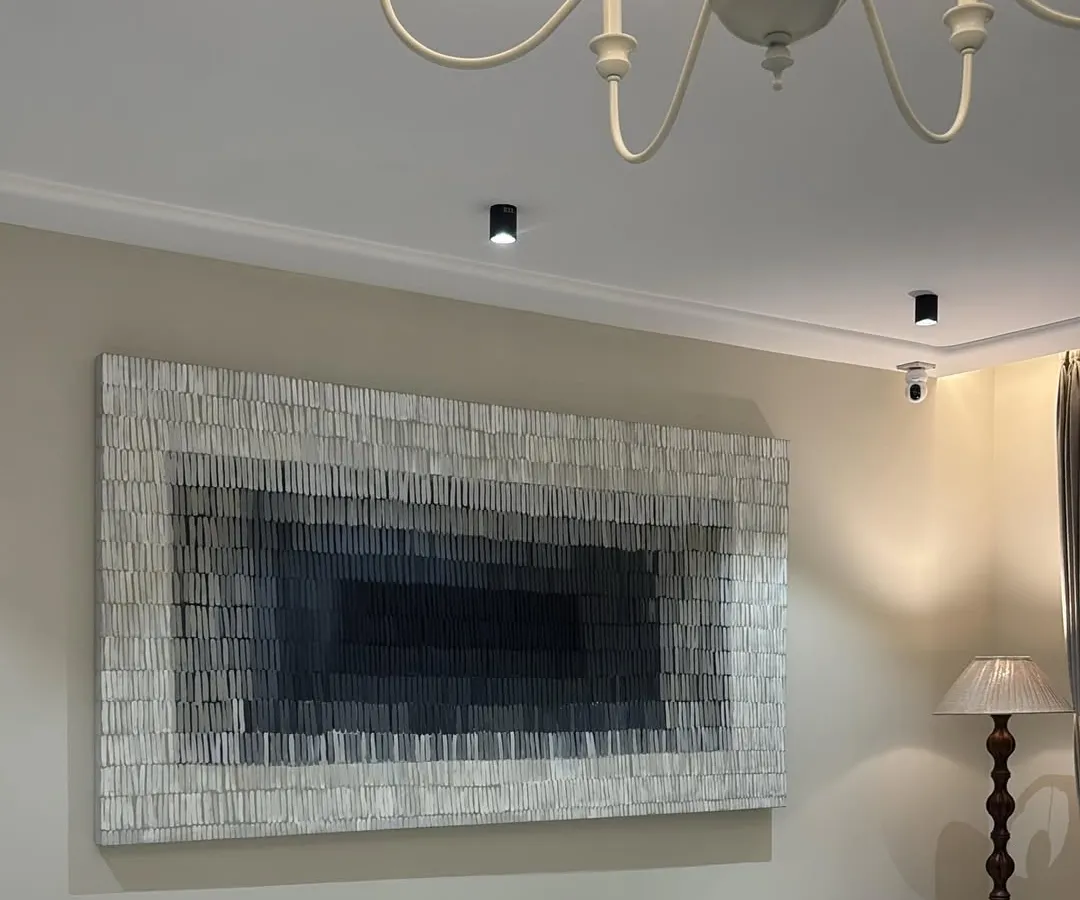 I love seeing my art transform a room. This 8-foot by 4-foot textured canvas, installed in a beautiful Gujarat residence, uses a gradient of grays to create depth and a sense of calm sophistication. It's a great example of how large-scale minimalist art can make a powerful statement.