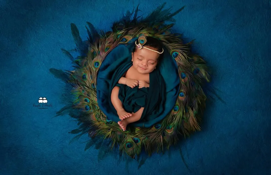 Our special 'Little Krishna' themed newborn shoot. We create a serene and beautiful setting with peacock feathers and soft fabrics to capture your little one as a divine 'natkhat Nandlal'.