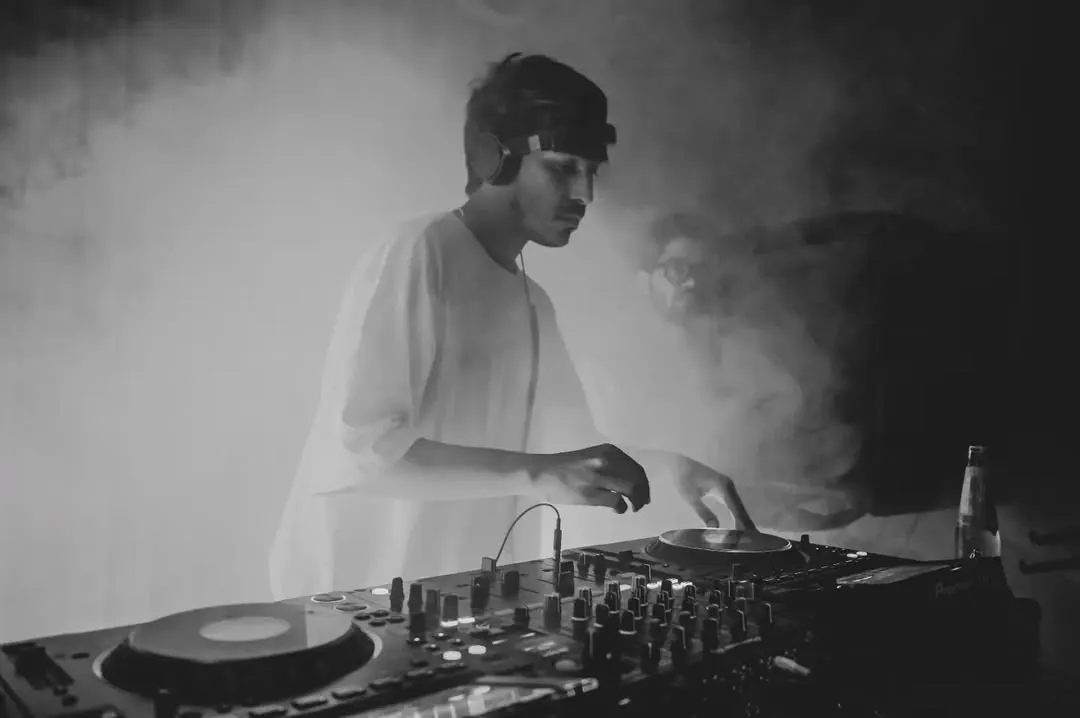 Caught in the zone during a set for Dance Ok Please. For me, it's about creating an atmosphere where the music takes over, blending deep cuts and heavy basslines to keep the floor moving. This black and white shot perfectly captures that smoky, intense club vibe.