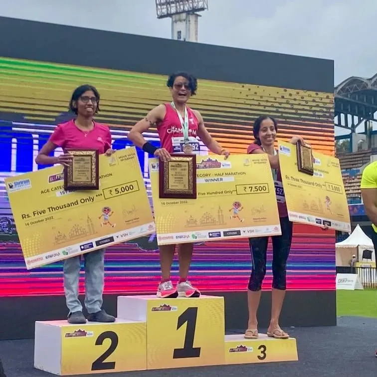 As a coach, I lead from the front. Here I am on the podium after a first-place age category finish in the Bengaluru Half Marathon. I bring the same dedication to my own races as I do to coaching you for yours.