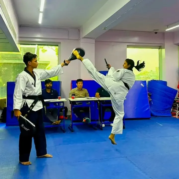 The pursuit of perfection in every move. Here, our black belt student Vanshika demonstrates a flawless high kick during a technique drill, showcasing the flexibility and precision required for scoring at the highest levels.