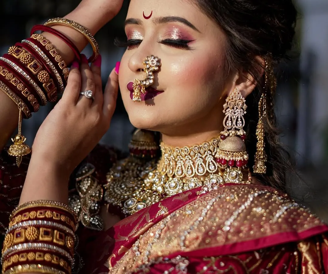 A close-up of a classic Maharashtrian bride. I specialize in perfecting every detail, from the `Chandrakor` bindi to the soft, glowing skin that complements the rich textures of the `Navari` saree.