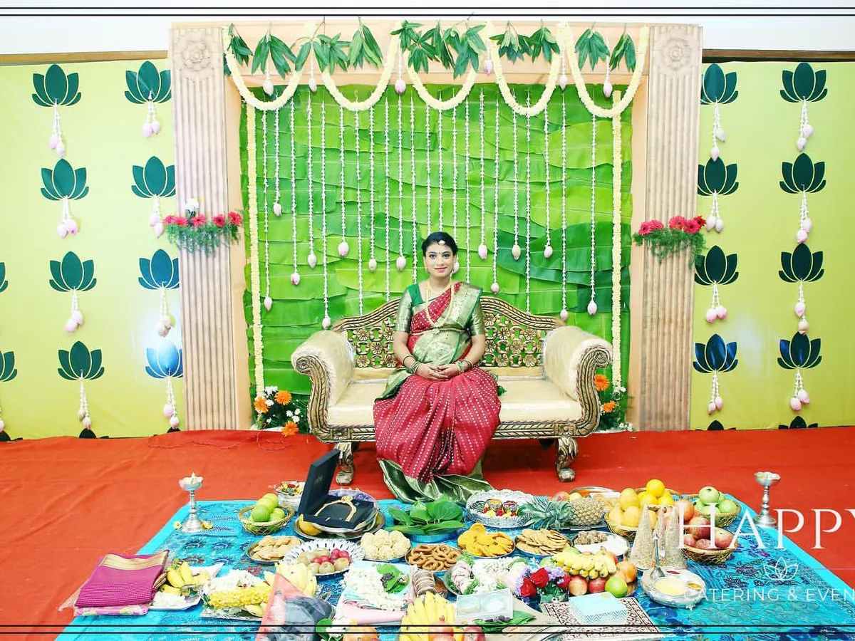We create serene and traditional setups for baby showers, like this Seemantham ceremony. The decor features a backdrop of banana leaves and jasmine garlands, with a comfortable space for the mother-to-be and the ceremonial offerings.