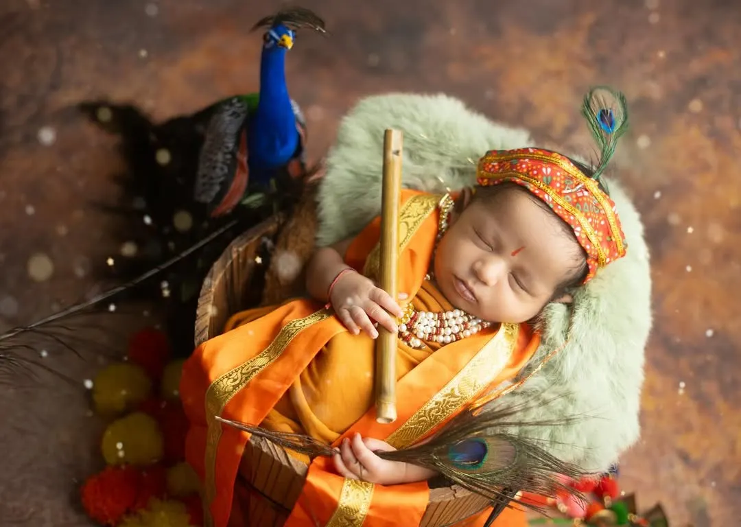 This is my Little Kanha, peacefully dreaming. I specialize in creating these divine, themed newborn shoots for Janmashtami, complete with props like peacock feathers and a flute.