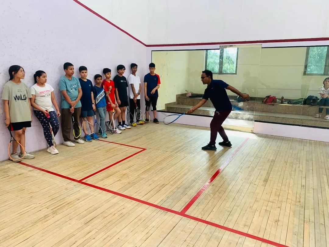 Our coaching philosophy is hands-on. Here, I am demonstrating proper swing mechanics to our junior players, ensuring they build a strong technical foundation from the very beginning of their squash journey.