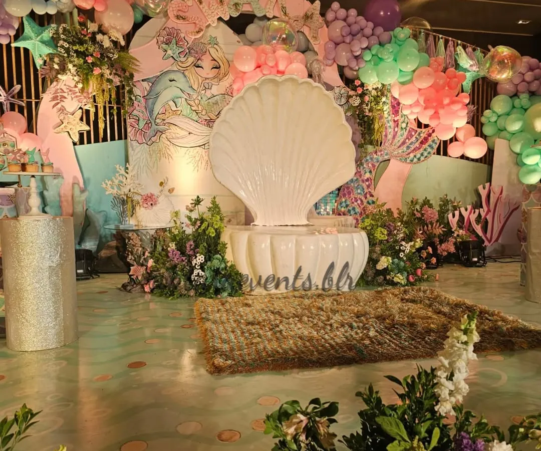 Welcome to our enchanting underwater kingdom! This mermaid-themed first birthday was a deep dive into detail, with a grand seashell throne, shimmering floors, and an ocean of balloons. I love creating these magical, immersive worlds for little ones.