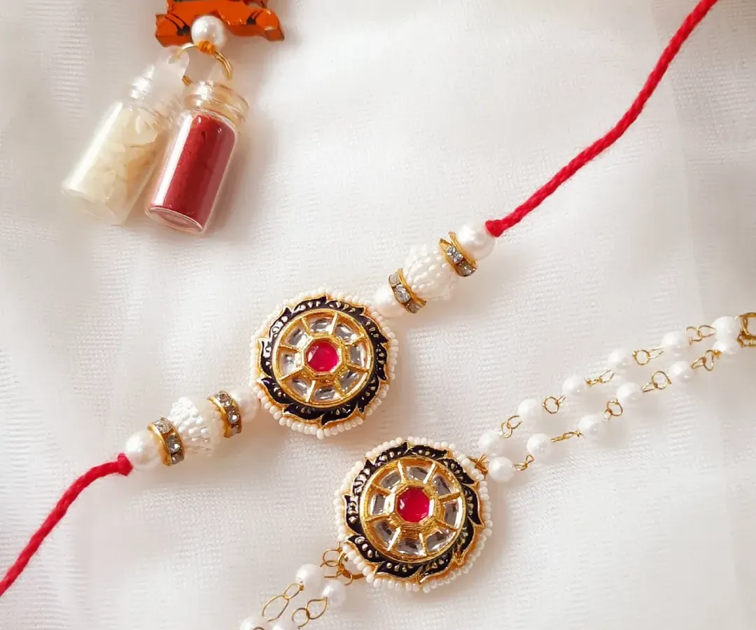 This is one of my favorite Bhai Bhabhi Rakhi sets. The traditional Kundan work on the bhai rakhi pairs perfectly with the delicate pearl Lumba for bhabhi. This set comes with Roli-Chawal to complete your Raksha Bandhan ceremony.