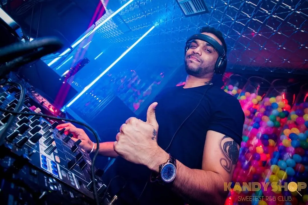 In the zone at Kandy Shop club, giving the crowd a thumbs up. I'm focused on reading the room and playing the right track at the right time, ensuring the energy stays high all night with a mix of Bollywood and R&B.