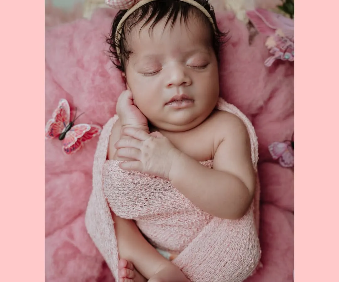 This is an example of a themed newborn portrait session. For this baby girl's photoshoot, I used a soft pink color palette, a gentle swaddle, and delicate butterfly props to create a sweet and dreamy image.