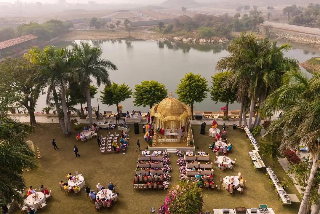 This aerial view captures the serene beauty of a lakeside mandap I designed at Shikarbadi Hotel, Udaipur. I specialize in utilizing stunning natural landscapes to create breathtaking backdrops for your most sacred vows, ensuring your destination wedding is as picturesque as it is memorable.