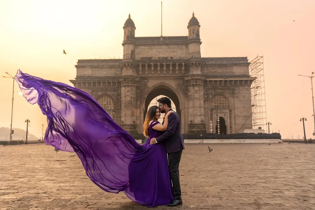 A magical moment captured at the Gateway of India. My purple flying gown with its magnificent trail adds a touch of royal elegance, perfect for creating iconic pre-wedding photos.
