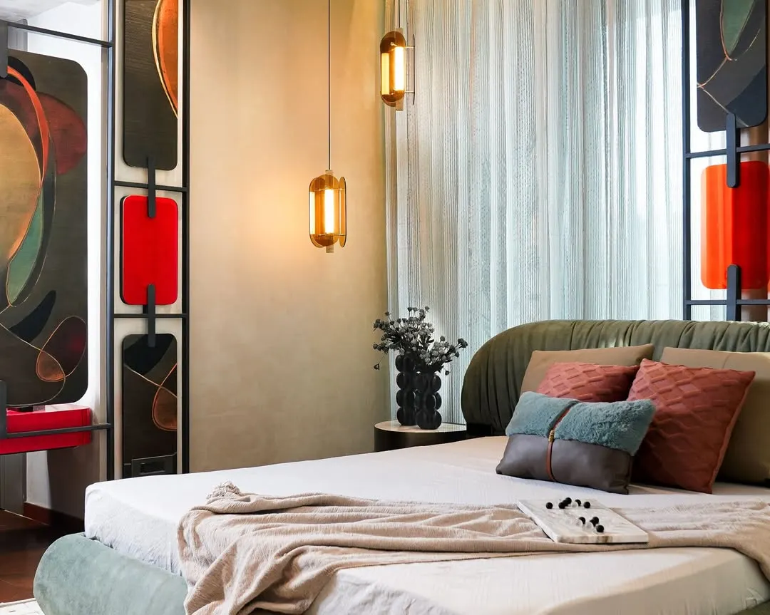 We envisioned this master bedroom as a sanctuary of comfort and character. A sage-green upholstered bed anchors the space, complemented by a sculptural, artistic headboard and warm ambient lighting, creating a room that feels both elegant and deeply personal.