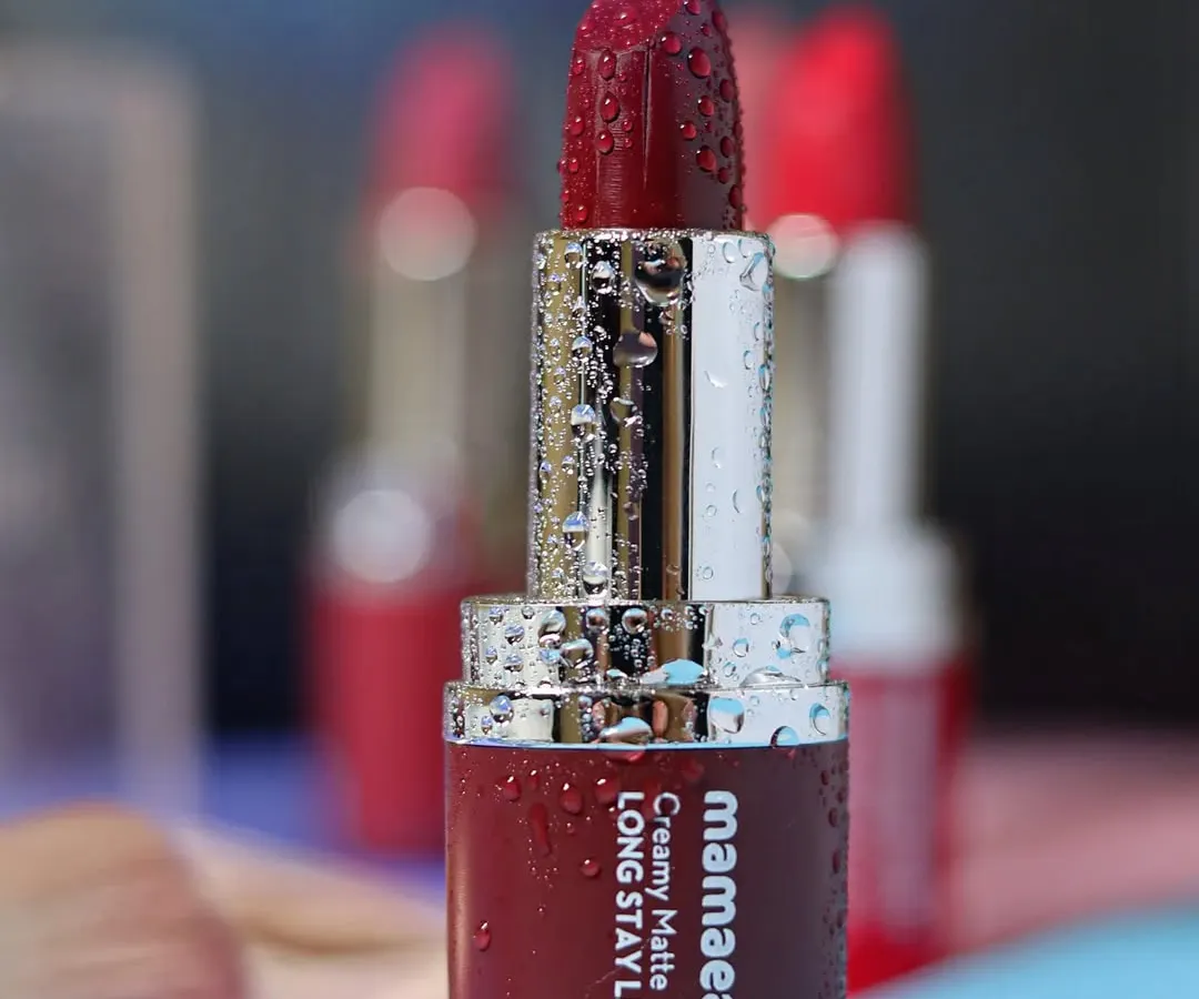 For cosmetic brands, I focus on creating a luxurious feel. This close-up of a Mamaearth matte lipstick, covered in fine water droplets, emphasizes its rich color and hydrating quality against a soft, dreamy background.