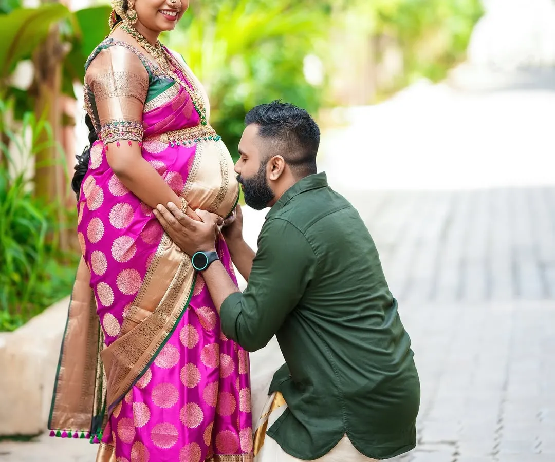 A tender moment during a traditional baby shower ceremony. We focus on capturing these quiet, unscripted interactions, like a father-to-be expressing his love, which make for truly timeless photographs.