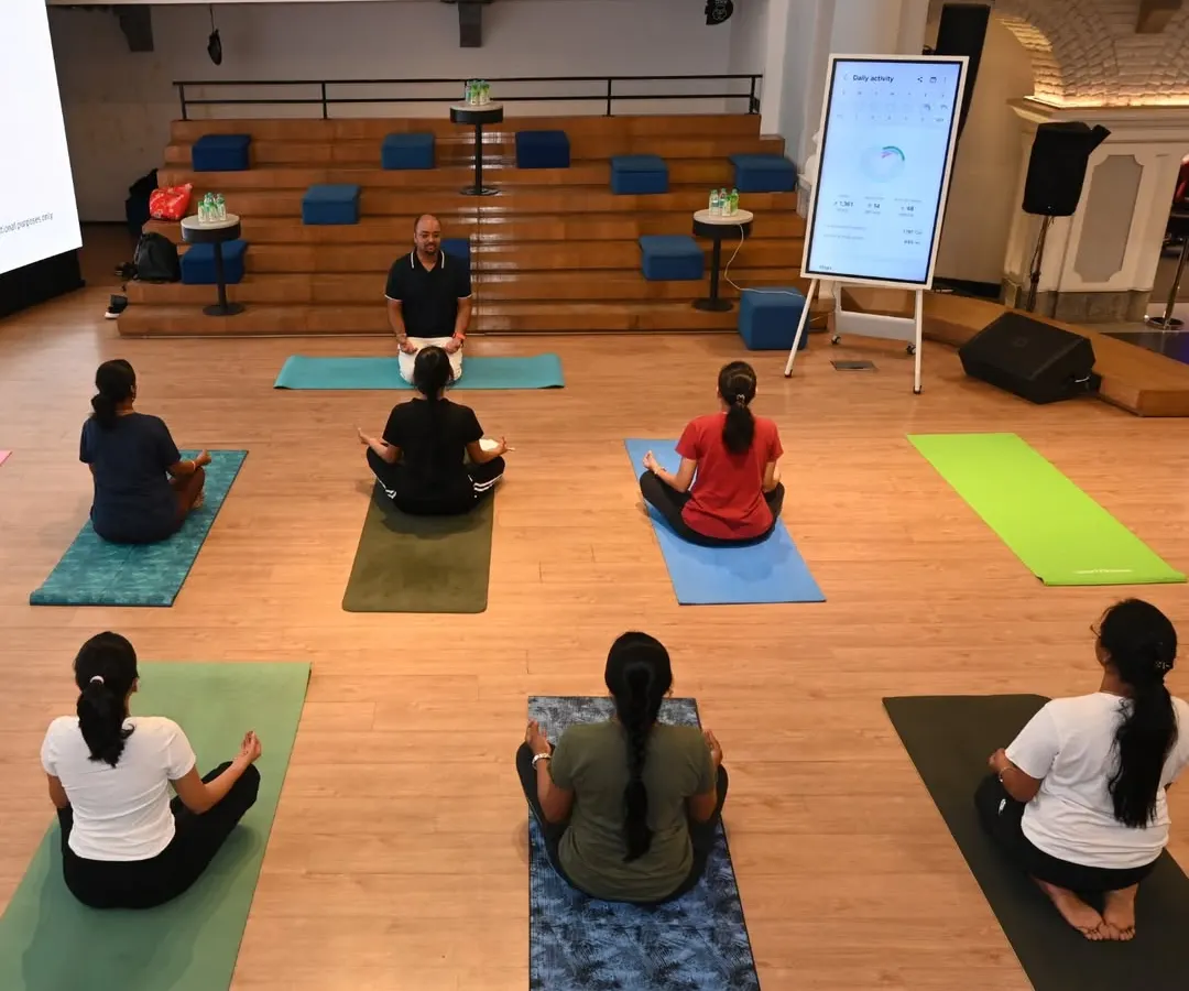 A moment of calm and focus during our on-site yoga session for Samsung India. We lead participants in Sukhasana (Easy Pose) with mindful breathing to help center the mind and prepare for a productive day, demonstrating how easily meditation can be integrated into the corporate environment.