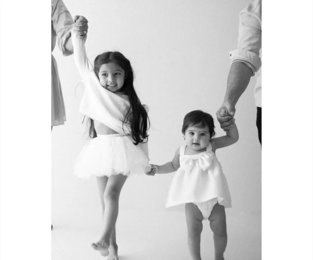 The bond between siblings is a story I love to tell. This timeless black and white family portrait captures that pure, unscripted connection as two sisters walk hand in hand, creating a memory of their shared childhood.