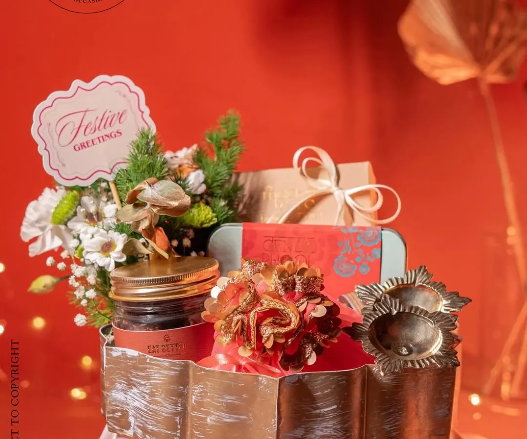 I designed this festive hamper to capture the warm glow of Diwali. Centered in a brushed gold metallic tray, it holds a curated selection of traditional treats, fragrant potpourri, and elegant diyas, all brought together with fresh floral accents. This is how I translate festive cheer into a tangible experience.