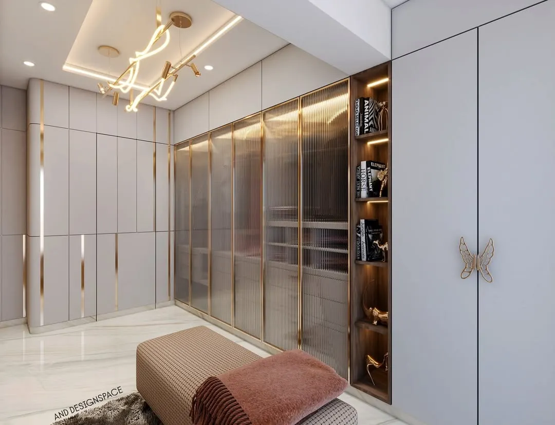 This 3D render showcases a walk-in wardrobe design that balances luxury and function. It features fluted glass doors with brass frames, integrated open shelving for display, and a modern chandelier, all contributing to a high-end, organized space.