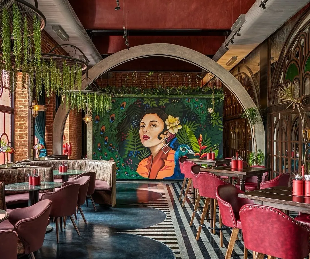 We love creating a mood. This painterly mural of a woman with a peacock became the stunning centerpiece for this restaurant's interior. It demonstrates our skill in creating sophisticated, atmospheric art that elevates the entire dining experience.