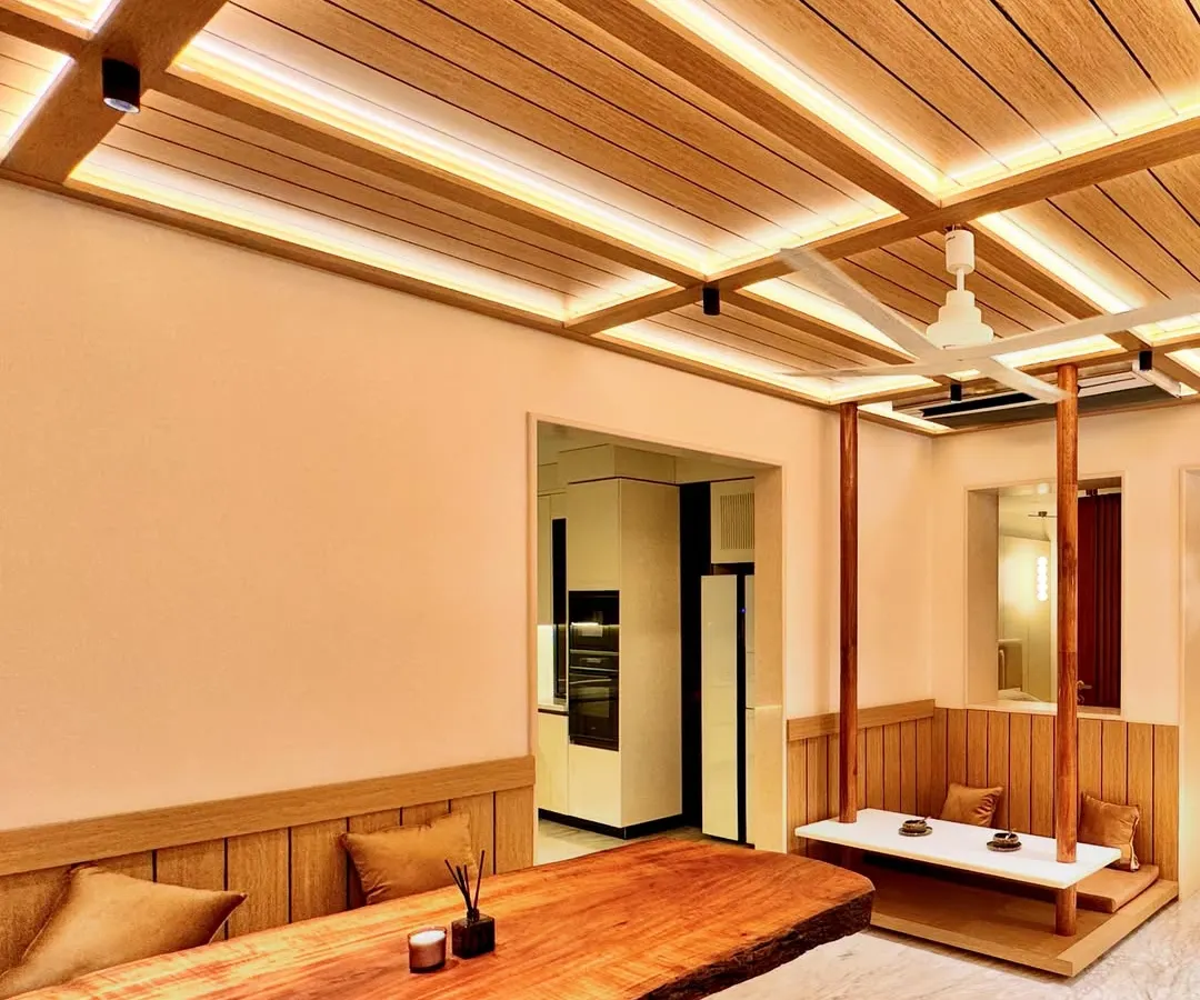 I designed this Zen-inspired dining area to be a space for connection and tranquility. The centerpiece is a live-edge wooden table, preserving the natural form of the tree. To create a unique, intimate setting, I designed a suspended bench that feels like a modern swing, encouraging a playful yet peaceful dining experience. The slatted wood ceiling with integrated lighting adds warmth and architectural rhythm.